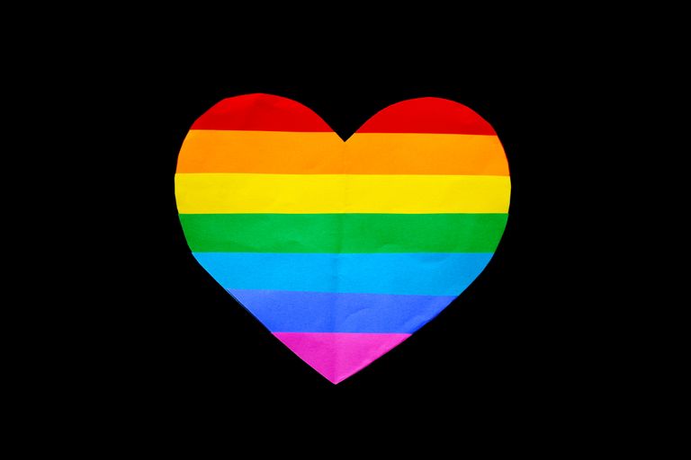 Colorful heart shape with rainbow stripes against a black background, representing LGBT pride and diversity.